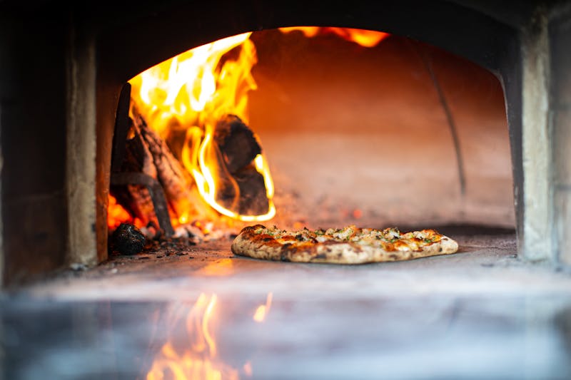Freshly baked via 313 pizza coming out of the oven